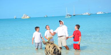captain and kids at swimming pigs in the bahamas