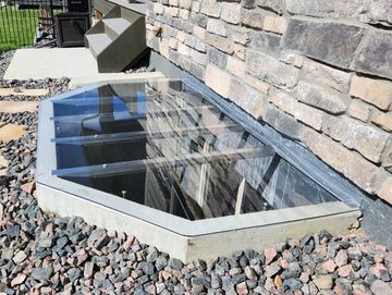 Custom window well covers in a concrete window well