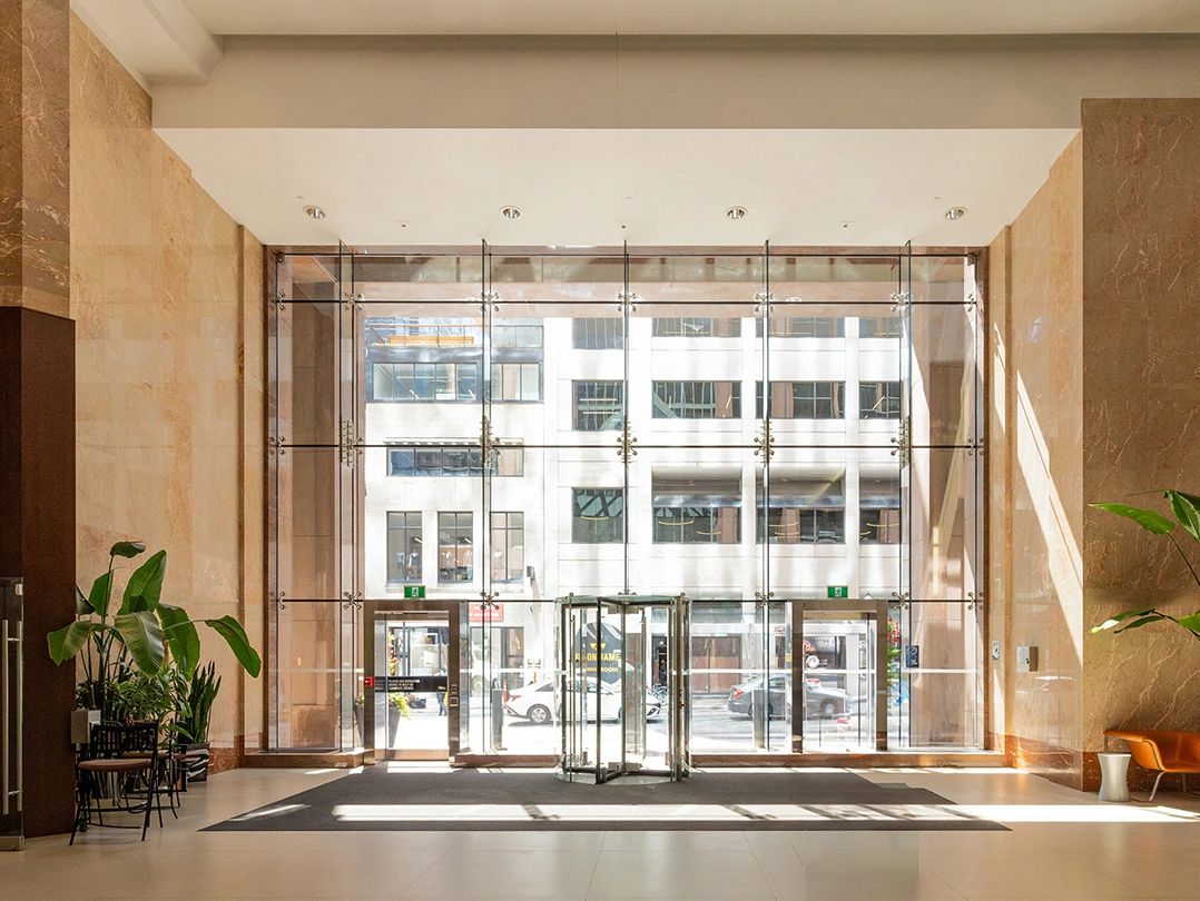 An office building lobby with all-glass entrance.