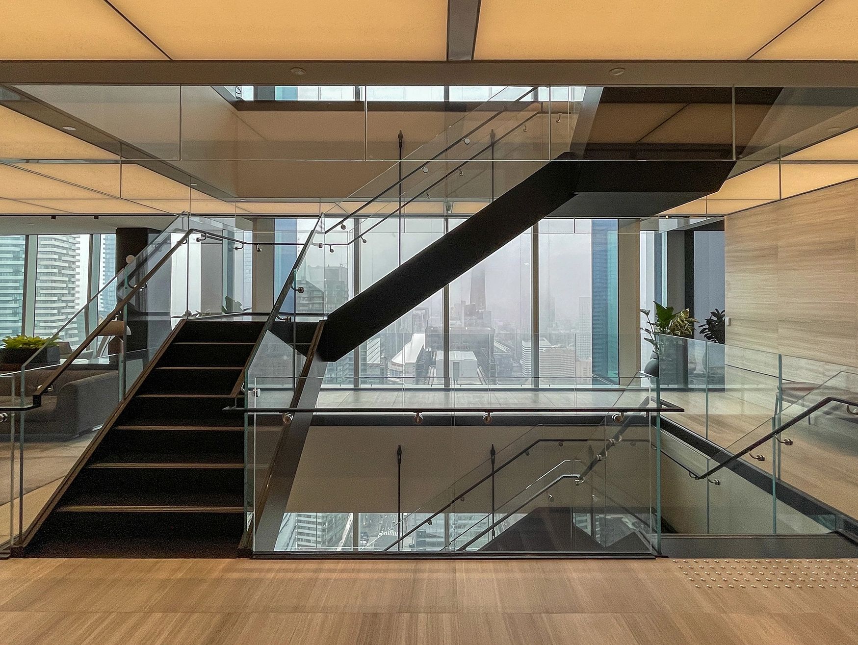 An architectural stair with glass railings.