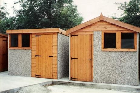 Two concrete store sheds. One with a pent roof and one with an apex roof.