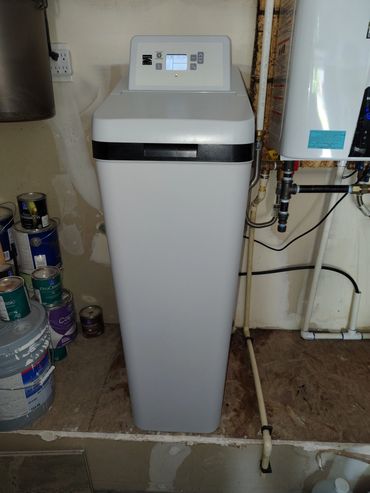 White replacement water softener installed by J Lo Plumbing.
