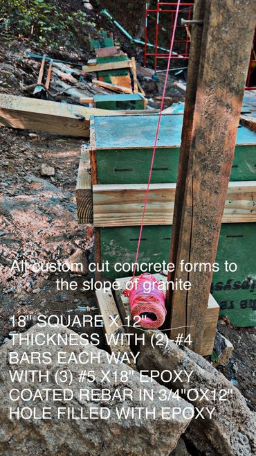 Custom cut concrete forms aligned to granite slope with rebar support.