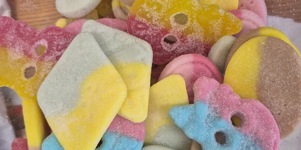 Colorful, sugar-coated gummy candies in various shapes and colors.