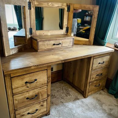 a rustic dressing table with a folding mirror and top draw. black handles and finished in a medium o