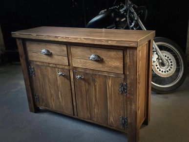 a chunky sideboard with 2 draws at the top and 2 doors at the bottom finished in dark oak wax.