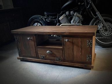 a solid chunky rustic tv unit finished in dark oak wax with iron fixings