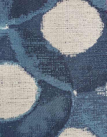 Close-up of a woven fabric with blue and white abstract patterns.