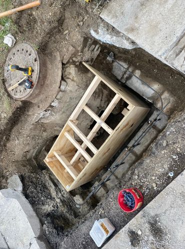 reconstructing failing catch basin, restoring curb, and repaving asphalt—all completed in-house