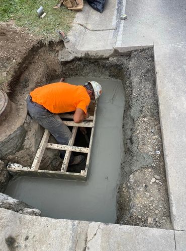 reconstructing failing catch basin, restoring curb, and repaving asphalt—all completed in-house