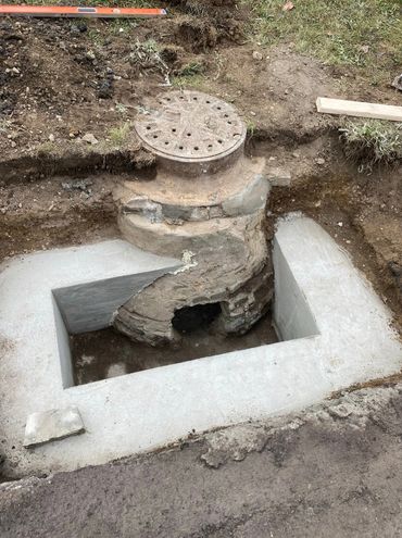 reconstructing failing catch basin, restoring curb, and repaving asphalt—all completed in-house