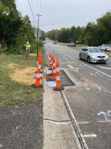 reconstructing failing catch basin, restoring curb, and repaving asphalt—all completed in-house