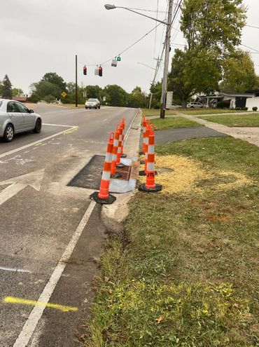 reconstructing failing catch basin, restoring curb, and repaving asphalt—all completed in-house