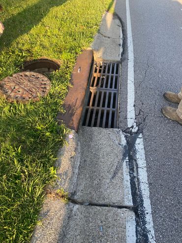 reconstructing failing catch basin, restoring curb, and repaving asphalt—all completed in-house