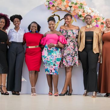 A group of Ugandan women smiling at an event.