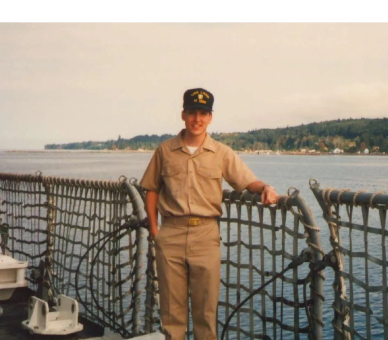 Young naval officer standing on a ship deck.