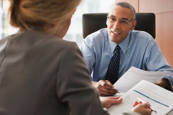 Businessman and colleague going over report