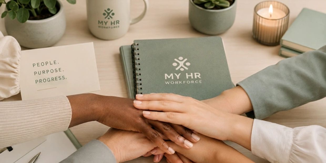 Diverse hands stacked over each other in unity on a desk.