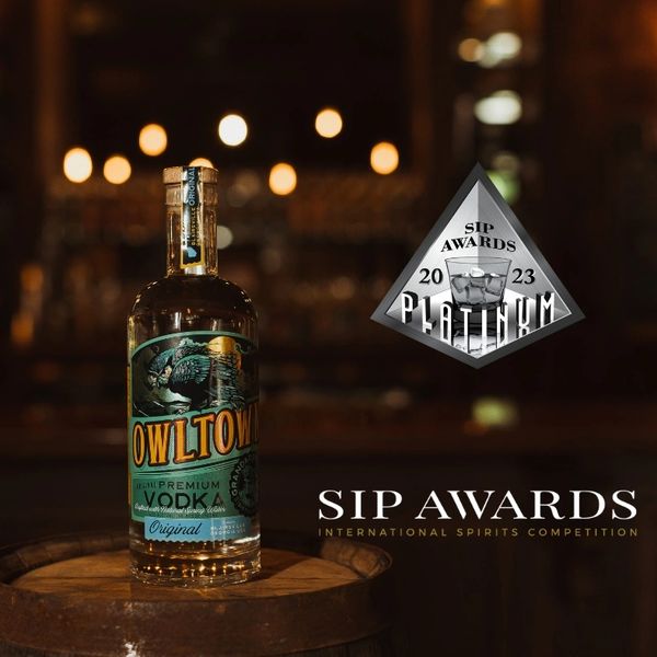 A photo of Owl Town Vodka Original Vodka with the SIP Awards Platinum Logo next to it.