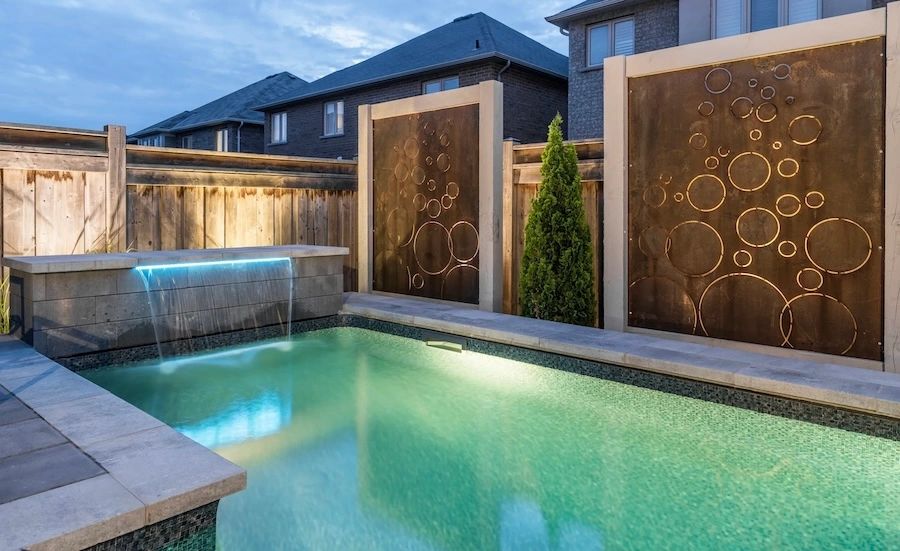 Landscape design in North Vancouver with pool, water feature, and custom privacy panels.