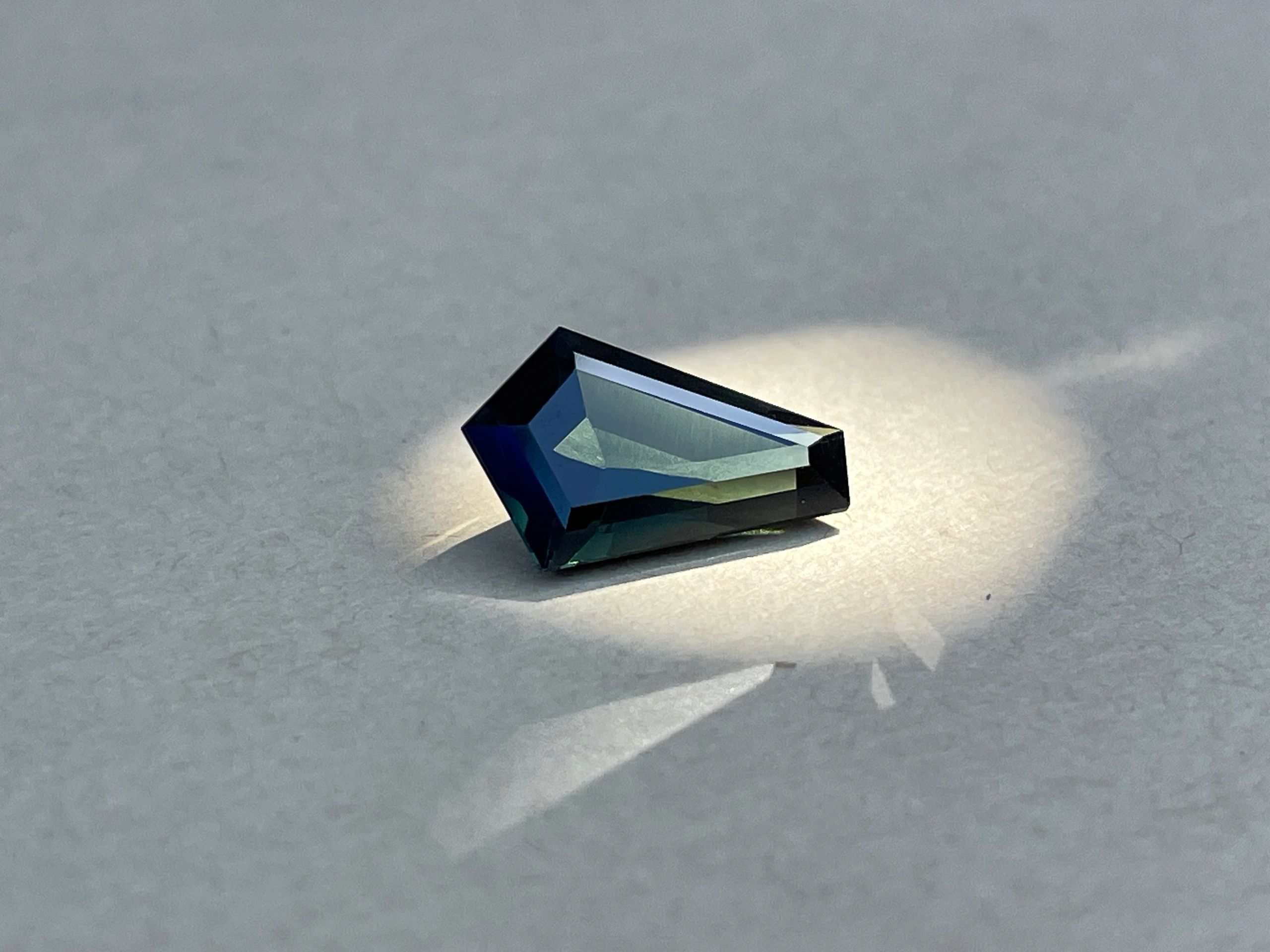 Coffin cut dark green sapphire.