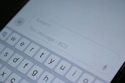 Close-up of a phone screen showing a text message input with on-screen keyboard.