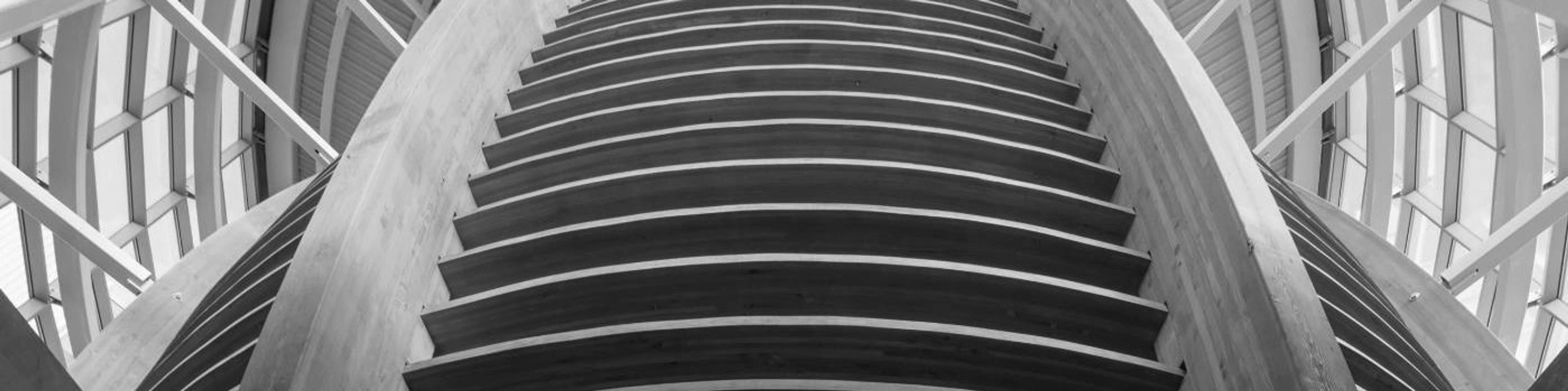 Stack of books next to pencils in a holder and a camera.