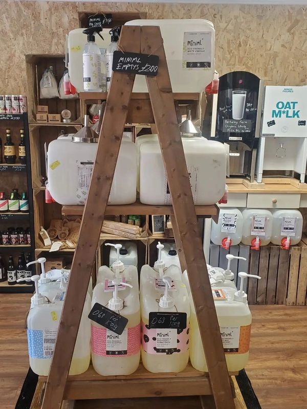 A stand full of 20ltr liquid containers from Miniml for people to refill from.