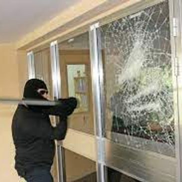 Security film demonstation with the coated glass being hit with a baseball bat.