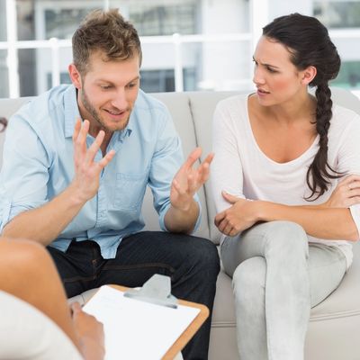 Two people talking to a counselor