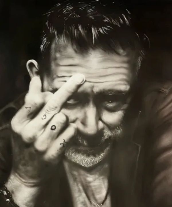 Black and white portrait of a man showing his middle finger with intense eyes.