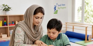 A woman helps a young boy with sensory toys at a learning center.