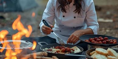 Chef preparing a meal at the campsite.