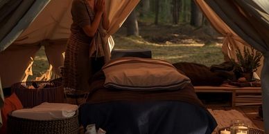 Spa provider preparing spa tent for massage.