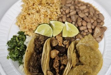 A plate of food with beans, rice and tacos.