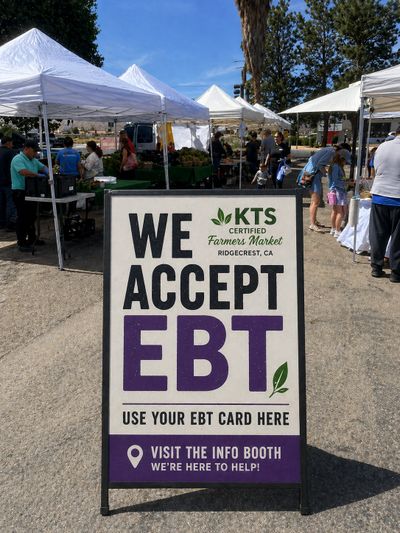 Sign at farmers market announcing EBT acceptance.