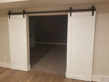 Routed groove painted sliding barn doors with matte black tracks