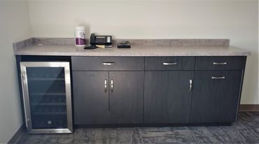 Commercial break room cabinetry with laminated door/drawer fronts and pull-out waste on the end