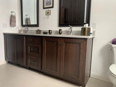 New construction house with stained maple bathroom vanity and oil rubbed bronze hardware
