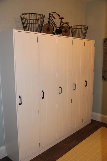 Grooved inset locker doors with black hardware and exposed hinges