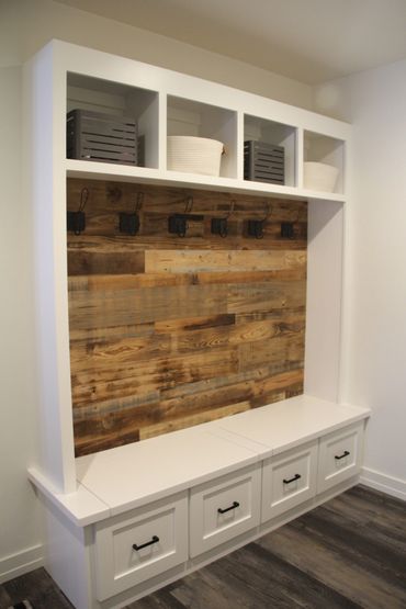 Locker area with lift-up bench top and custom rustic wood wall 