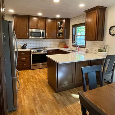 Kitchen remodel with new quartz countertops, appliances, and fixtures