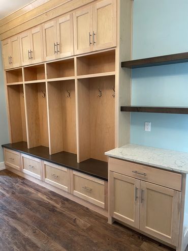 Clear stained maple cabinetry with dark stained shelves and bench top
