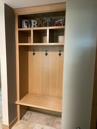 Open locker storage with decorative cubby space in stained maple