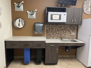 Commercial break room with trash pull-outs and ADA accessible sink