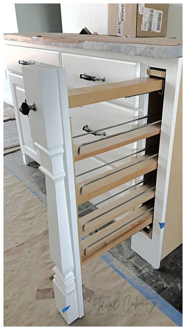 Hidden pull-out spice rack behind painted decorative leg