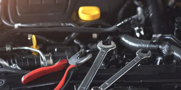 Wrenches sitting in an engine bay