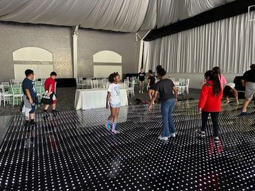 4th Grade Class enjoying a field trip. Dancing on the LED floor