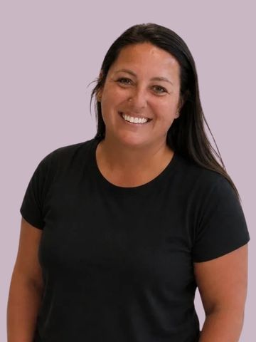 Smiling woman with long dark hair in black shirt.