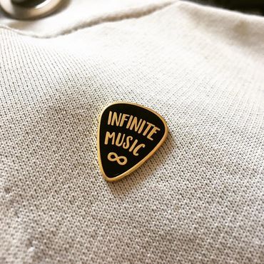 Gold and black cloisonné enamel pin in the shape of a guitar pick.